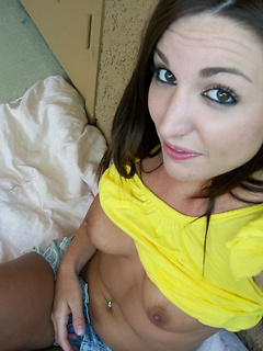 Cute girlfriend takes selfshot pictures out on the patio for her boyfriend